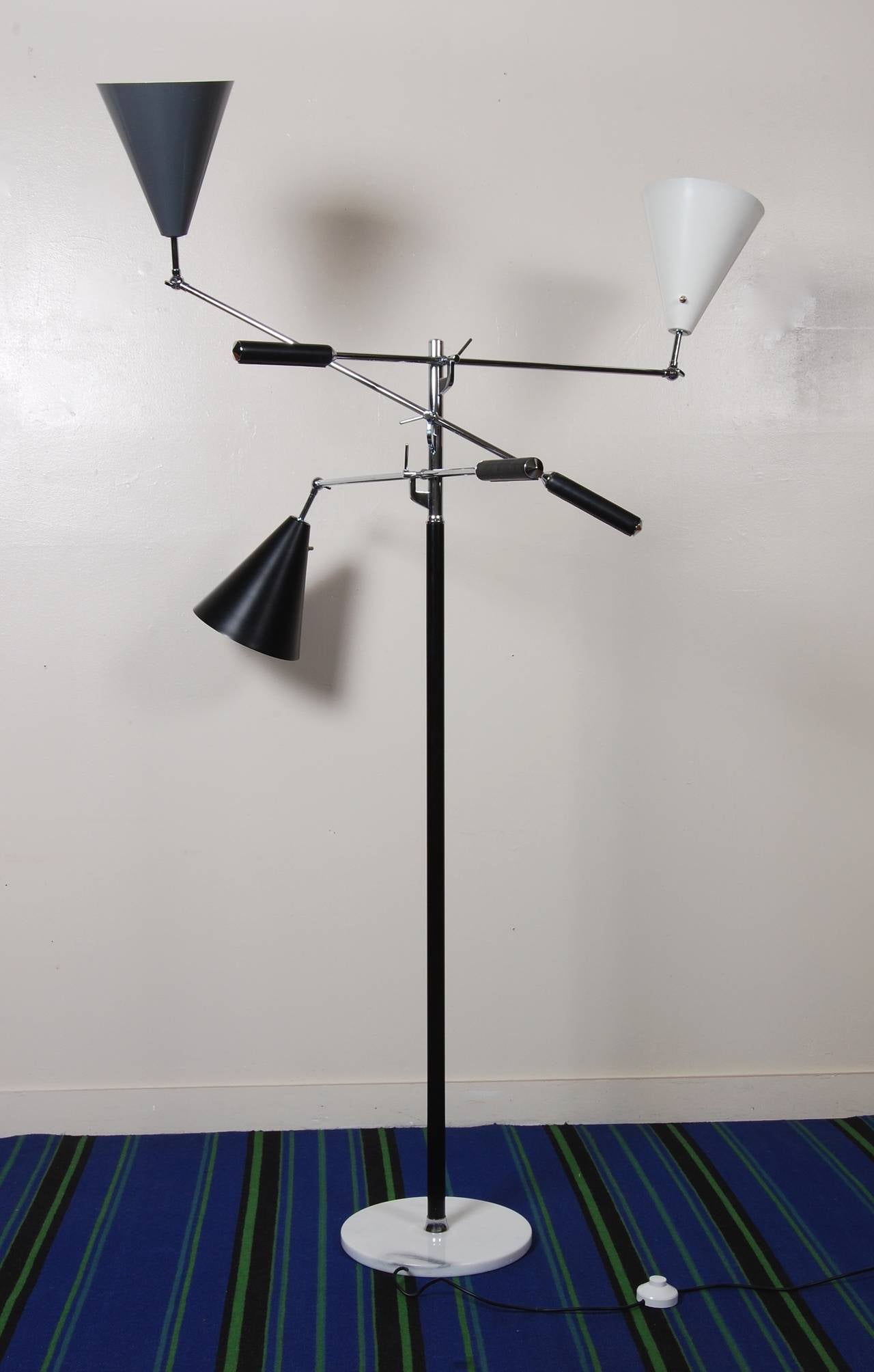 Early 1960s vintage Triennale floor lamp, this exceptional example has grey, black and white lacquered shades. The three adjustable arms have leather covered counter weights with chrome caps. Resting on a Carrara marble base, this lamp has been