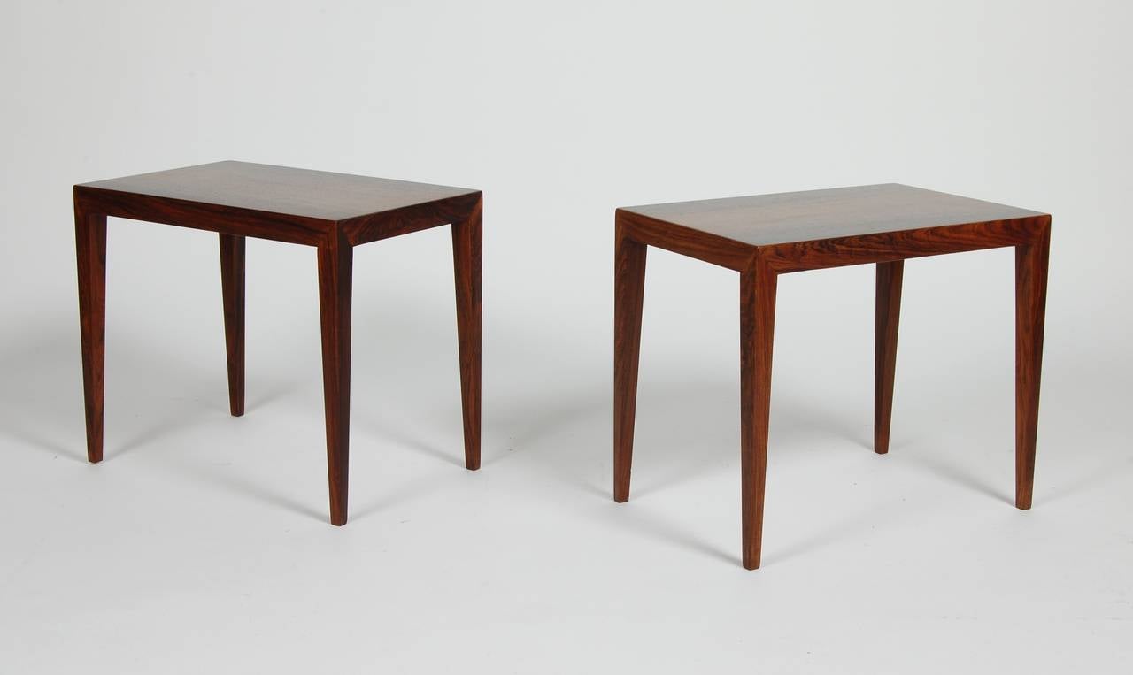 Side tables in rosewood by Danish designer Severin Hansen having a modern architectural sensibility, simple, clean and attractive. Square tapered legs, crisp edges and matched rosewood tops. The two can be placed together to create a small impromptu