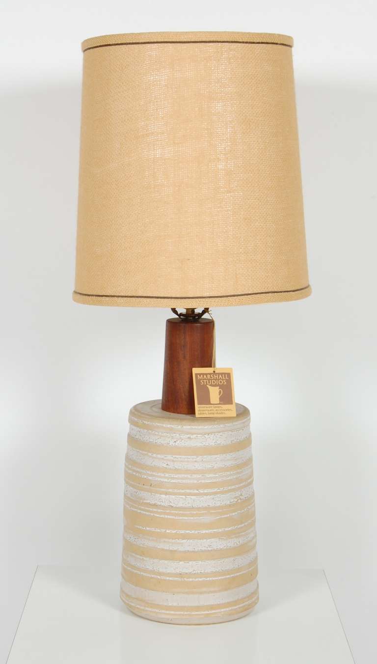 Hand thrown ceramic table lamp by the Martz Studios, having an earth toned glazes with walnut accents. The lamp's measurements are the diameter of the base to the top of the socket.