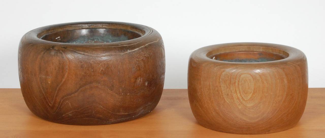 Two Japanese hibachis that can be used as planters, textural circular wood forms with brass liners. The smaller hibachi is 13