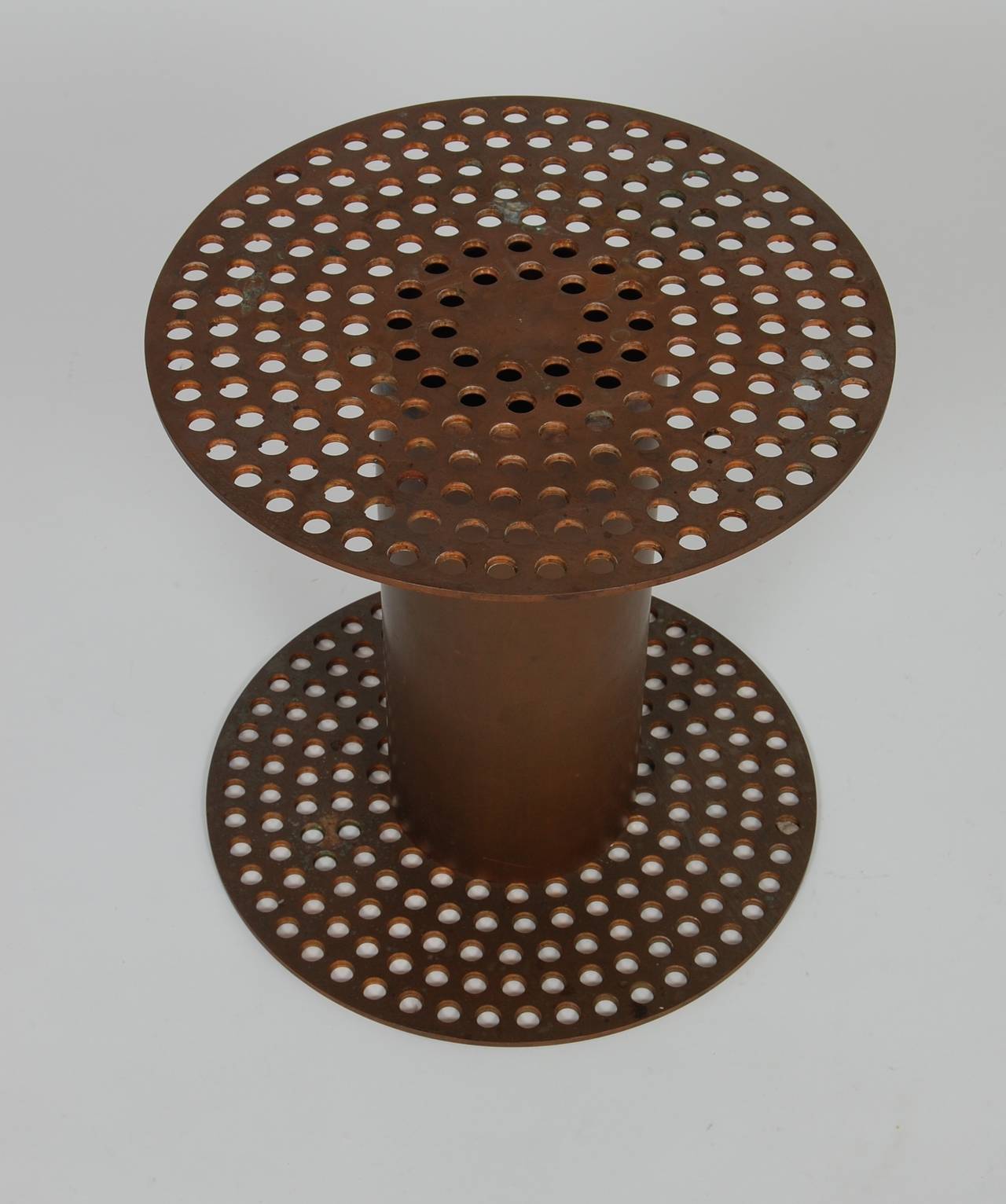Solid brass side table with perforations on the top and base, great patina to the surface.