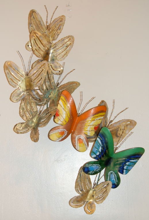 Colorful mix of torch cut brass forms with two enamel ones creating a flock of butterflies by Jere dated 1969. Can be mounted either horizontally or vertically.
