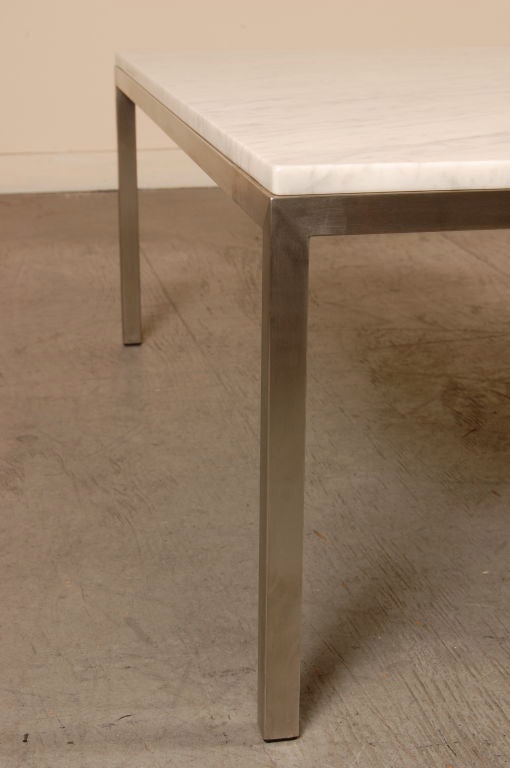 Carrera marble topped coffee table which is beautifully veined and a finely mitered brushed stainless steel frame. A wonderful vintage example of the International Design aesthetic.