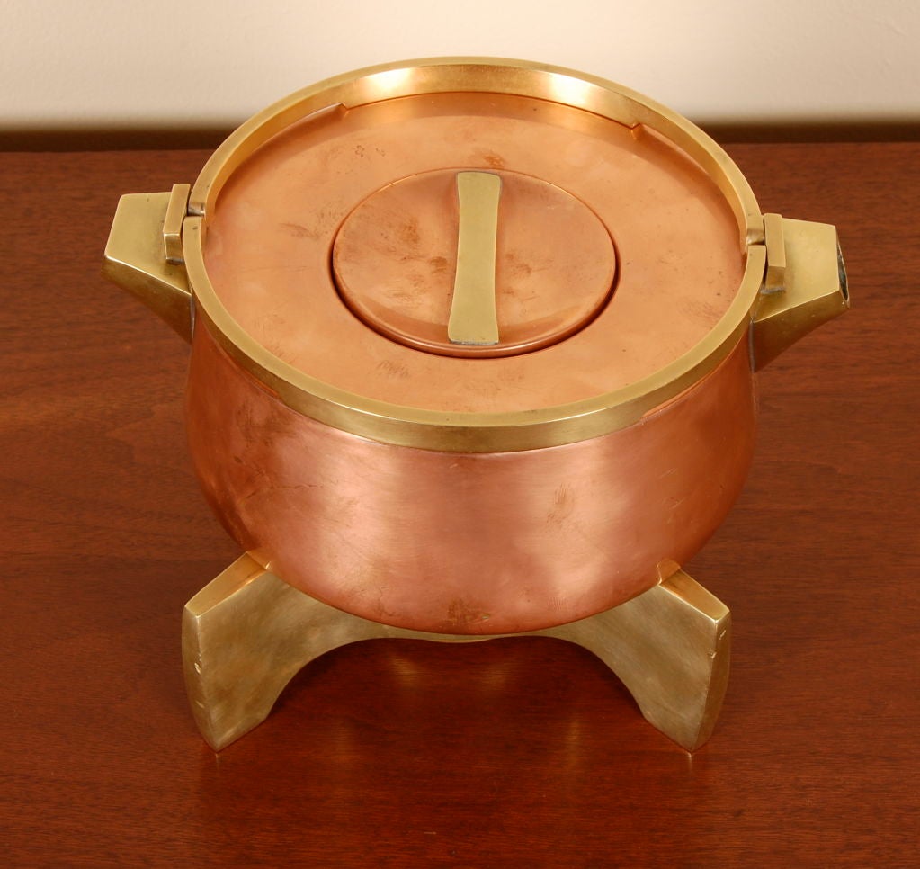 Sculptural copper and brass two spout teapot, finely hand crafted by Grubert and Baggs of Denmark with a great contrasting use of the warm metals. Resting on a impressive solid brass base with a refillable warmer and ceramic wick holder. Stamped