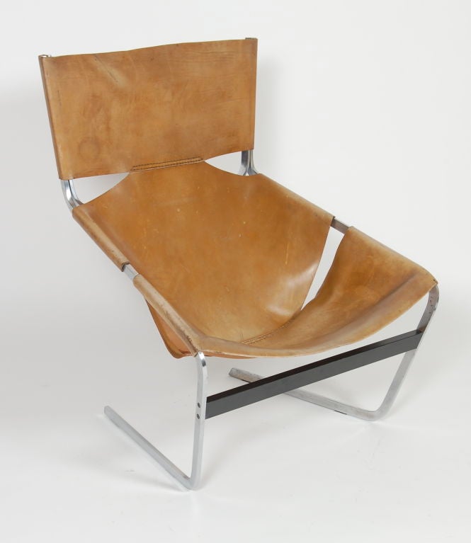 Rarely seen original F444 lounge by Pierre Paulin for Artifort. Saddle leather sling seat wrapped over a chrome frame.