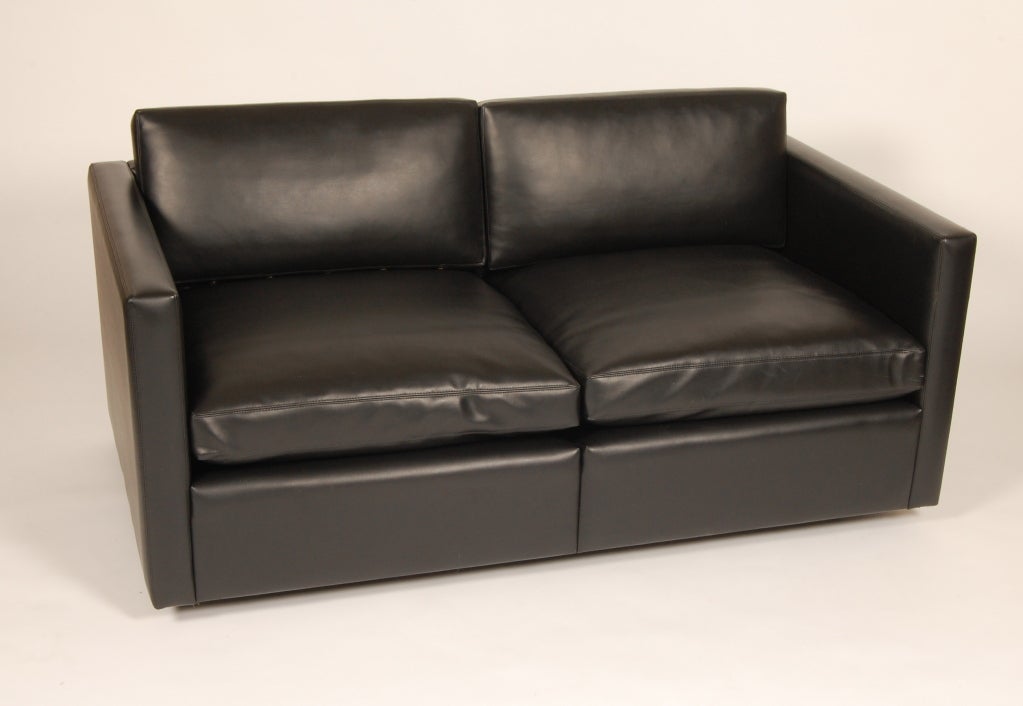 Knoll settee designed by Charles Pfister, all original example thick black vinyl upholstery with feather and down cushions. The six feet have adjustable glides.