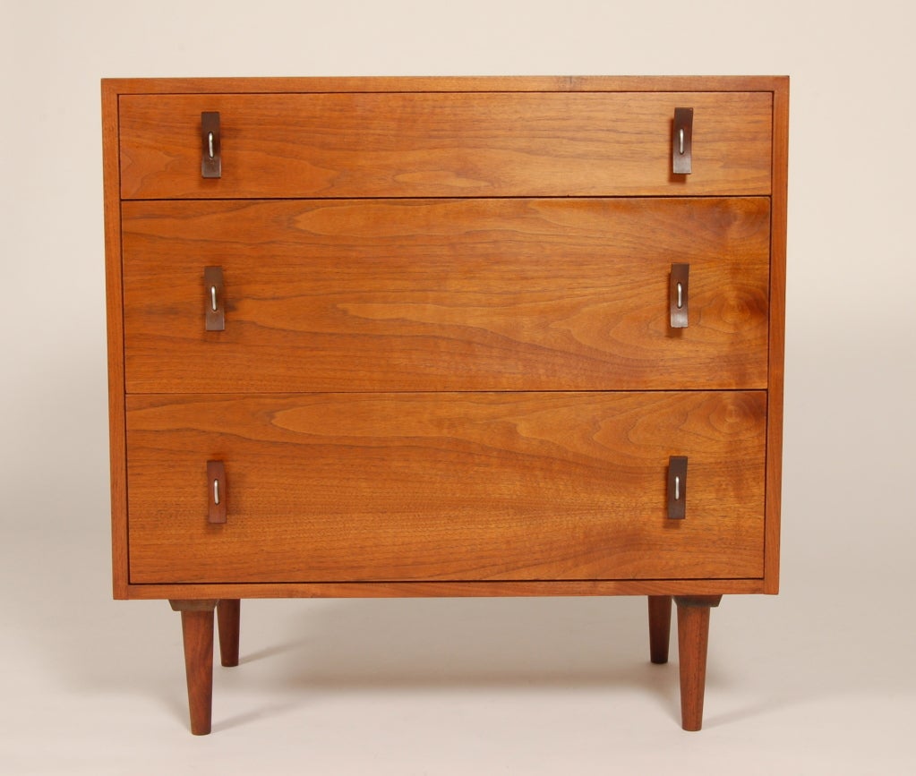 Three drawer dresser with curved wood handles and aluminum accents. Figured walnut surfaces designed for Glenn of California by Stanley Young.