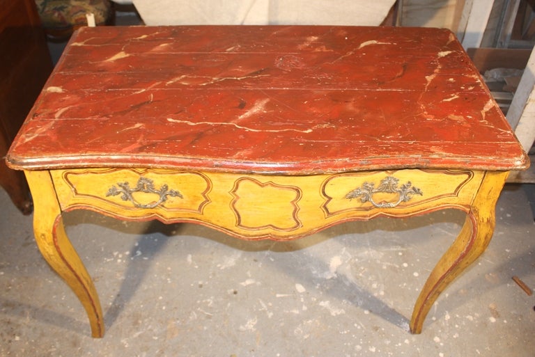 A stunning French or Italian Louis XV period one-drawer console table circa 1770 in bright yellow ochre paint with a cinnabar faux marble top, for the estate of Pierre Moulin and Pierre LeVec, founders of Pierre Deux.