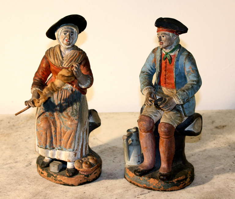 A rare pair of early 19th century French terra cotta figurines depicting a peasant man and a woman in period costume.  Probably Provencale, circa 1800, it is exremely rare to find a true pair of these fragile examples surviving.  They are in