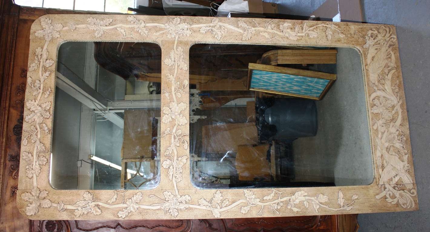 A large pine frame mirror with 2 glass plates, carved overall with vines, leaves, birds etc., signed and dated lower right corner 