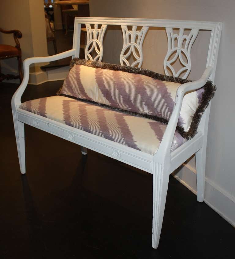 A nice 19th century Italian neoclassic painted bench in chalky grey-white paint, with carved back panels and apron, on tapered fluted legs.  The slip seat and back cushion are in custom lavender silk Ikat fabric.
