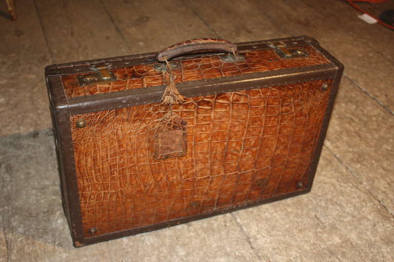 A really nice quality and condition, this 1920's era French suitcase retains its original brass latches, linen interior and alligator handle.  It even has the original tassel and name tag in alligator skin.  From the estate of Pierre Moulin, founder