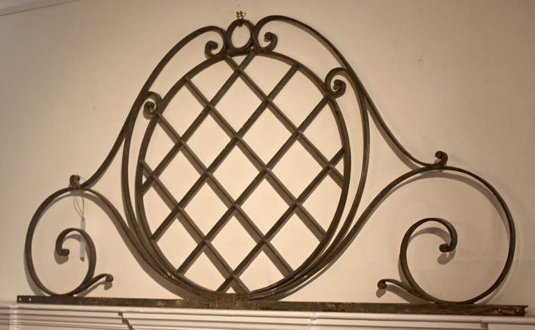 A 19th century decorative wrought iron element, perfect for a small headboard or over a mantle.