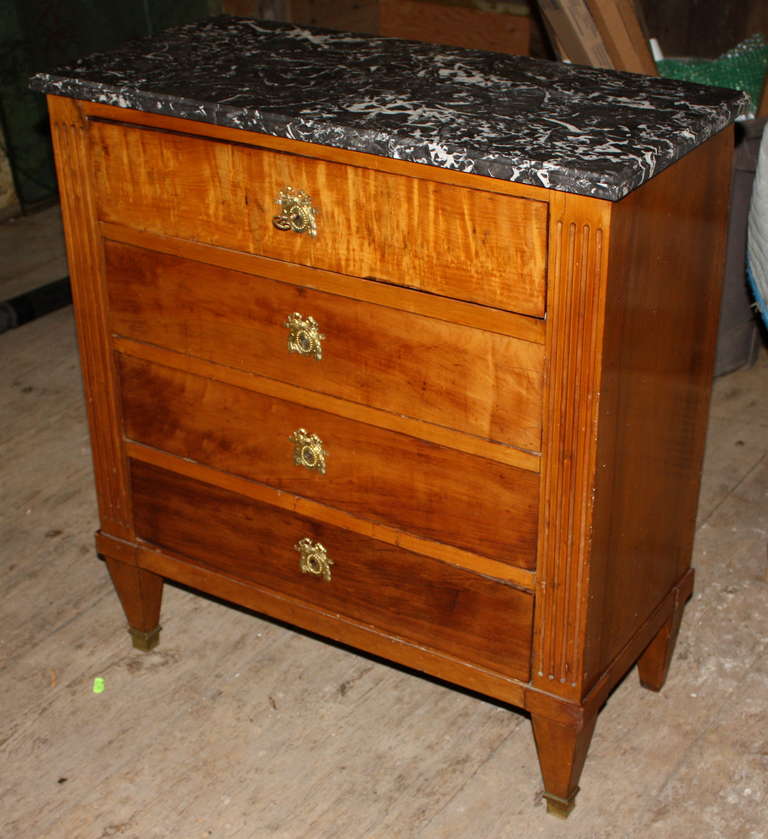 A nice early 19th century Louis XVI style 4 drawer petite commode in fruitwood, with drop-front top drawer concealing a leather writing surface and interior pencil drawers, original grey marble top and brass hardware.  Unusually shallow depth.