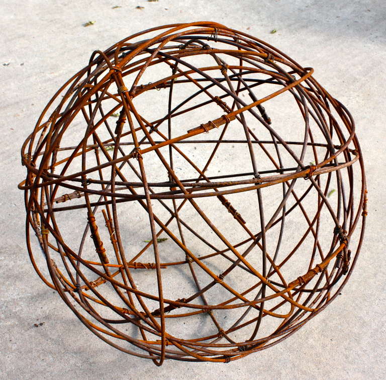 A large steel wire garden sphere signed and numbered by sculptor Brad Oliver.