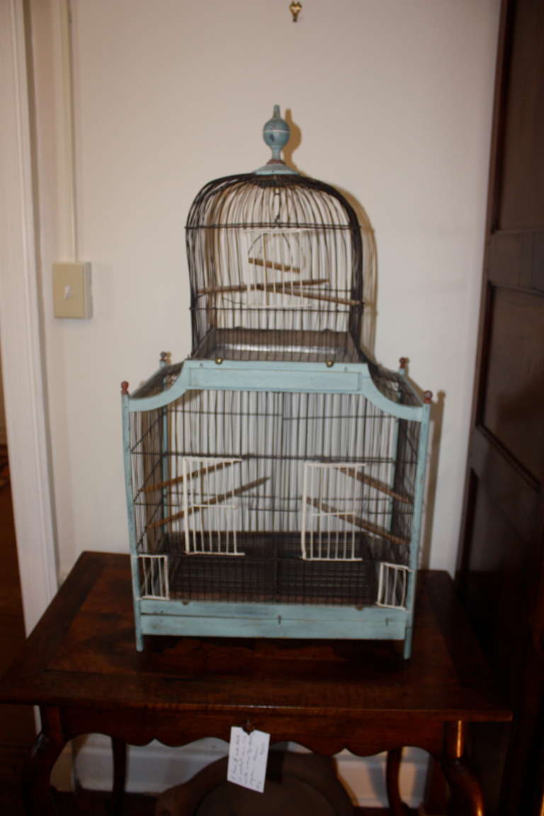 A French dome-top birdcage in wood and wire, painted light blue and white, with its original tin tray, circa 1870.