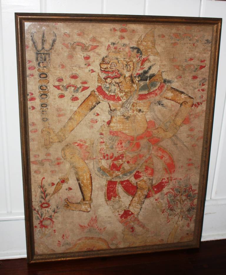 An interesting and rare Balinese painting on silk depicting a dancer costumed as a Brang Lion doing a 