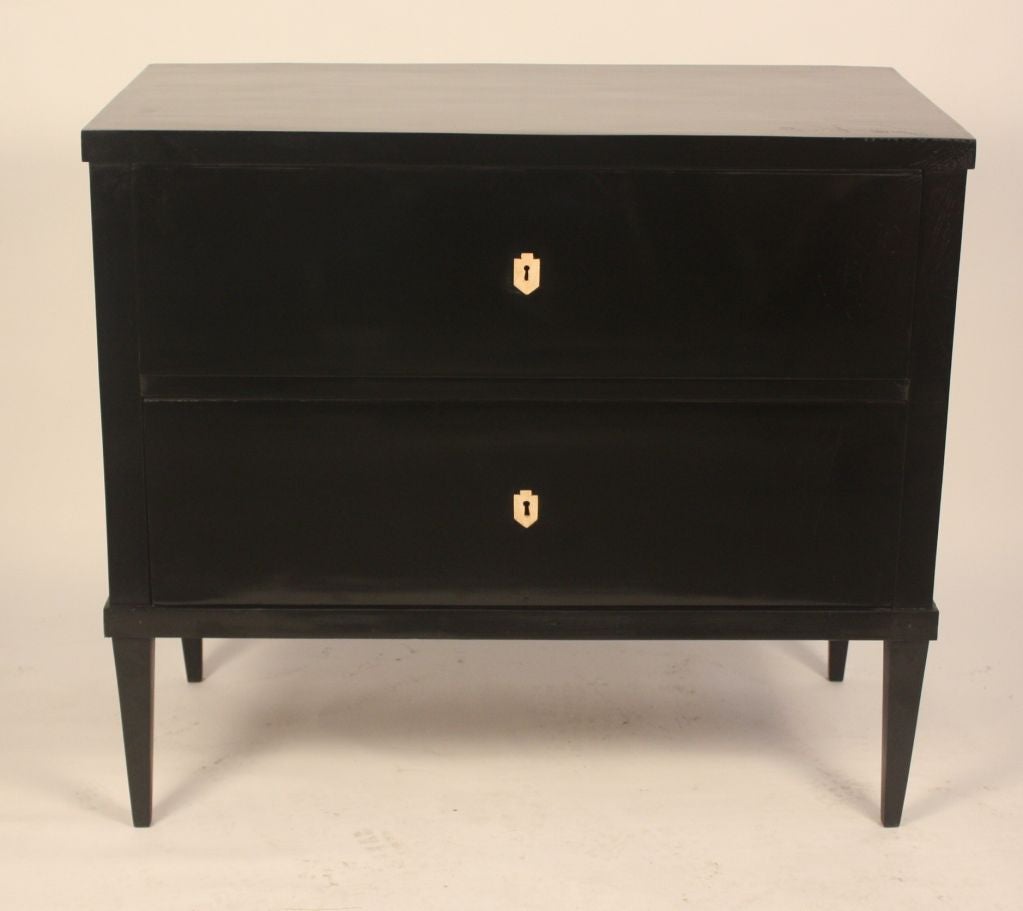 A rare pair of black lacquer 2-drawer commodes, Directoire period, with ivory key escutcheons and original working locks.