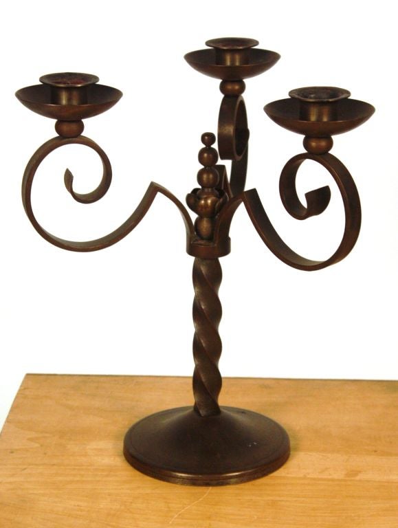 A nice pair of French 3-arm candelabras in wrought-iron with scrolled arms and a twist-form base. Very nice patina.