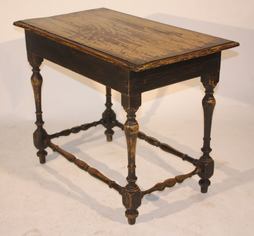 A nice old tavern table with a yellow ochre painted finish.