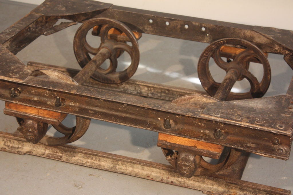 An unusual small-size industrial coal trolley in steel, modified for use as a coffee table, includes a section of track.
