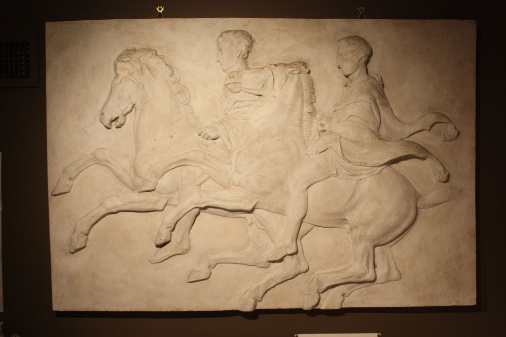 An unusual classical relief in plaster, French circa 1930, issued by the Louvre Museum (metal plaque on reverse) taken from a casting of the horsemen relief in the Parthenon.  Great patina and impressive size.
