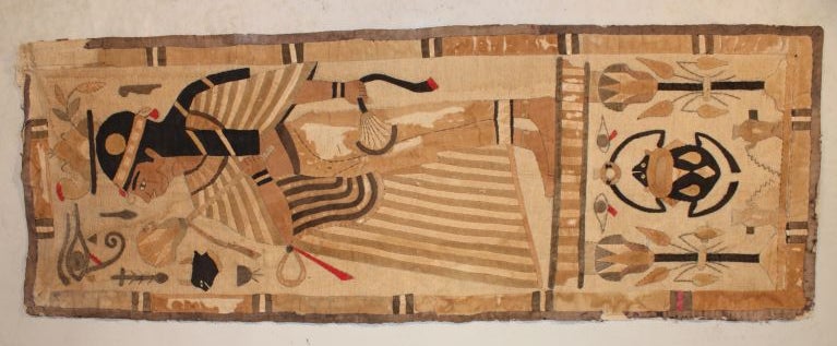 A hand-sewn Egyptian inspired tapestry, probably French, early 19th century, in linen and silk, depicting a standing figure surrounded by miscelaneous hieroglyphics.  Egyptomania was inspired by the discoveries by Napoleon during his Egyptian