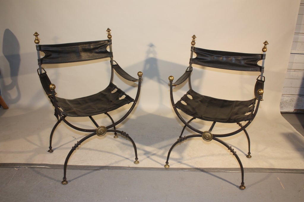 A set of 4 decorative Italian Renaissance-style armchairs in wrought iron and brass, with leather sling seats, arms and backs, circa 1940, Italian or French.  Can split the set.

**** only 4 left ***  @ $4500 the set