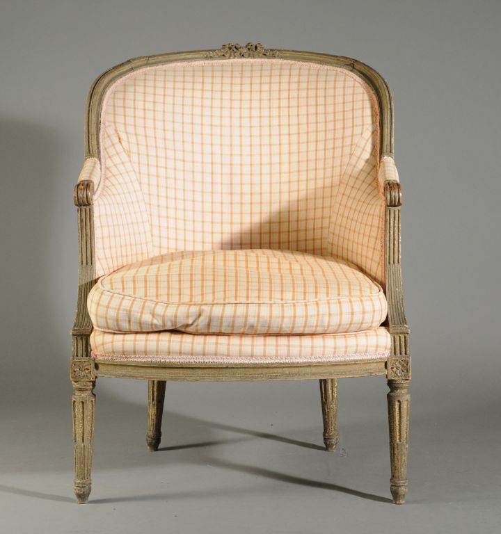 A Louis XVI style bergere chair in old green/grey painted finish, French 19th century, with unusually tall fluted legs, and a desireable 