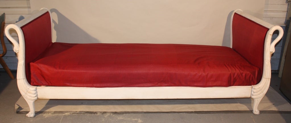 A Second Empire French daybed, circa 1870, with swan motif, in old painted finish, currently un-upholstered..
