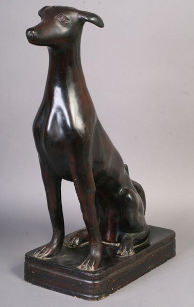 An unusual lincrusta sculpture of a seated dog with a dark brown finish, Italian, circa 1930.