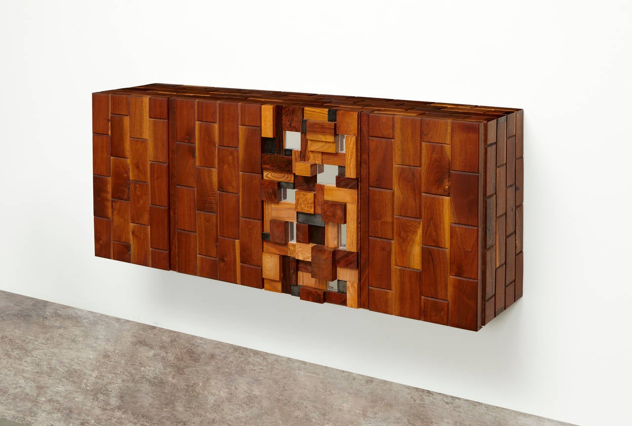 PHILLIP LLOYD POWELL
Wall-mounted cabinet, 1977
Walnut, oak, rosewood, ebony, burlwood, mirrored glass. 
24 x 60 x 15.3 in

The former owner commissioned Powell to create this piece, along with several other unique works during the 1970s.