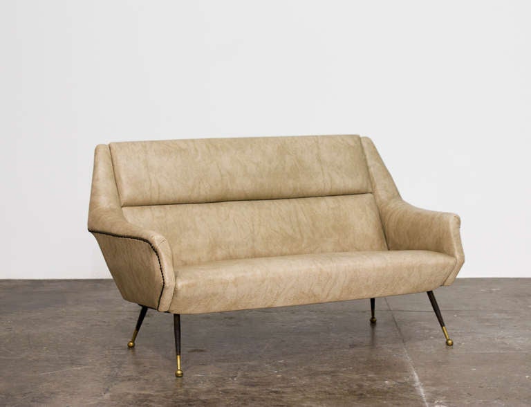 GIO PONTI
Settee, ca. 1945
Brass, painted metal, vinyl.

Sold with a letter of authenticity issued by the Ponti Foundation.