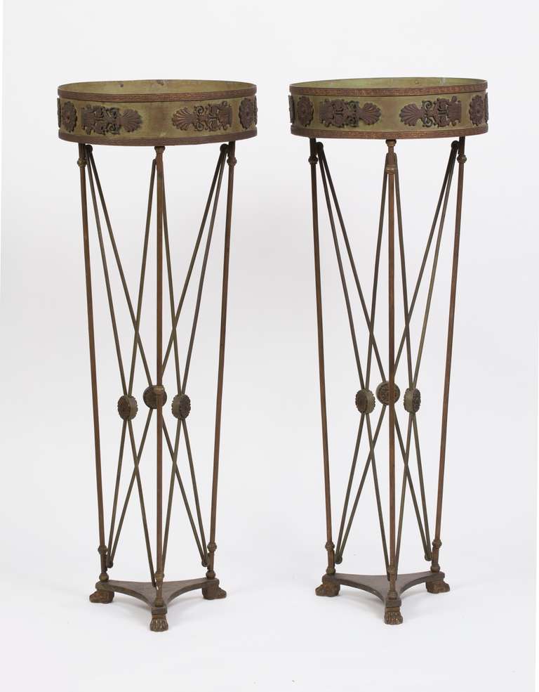 Each circular basin with applied Greek key molding and trophy mounts of palmettes and rosettes supported on bronze legs joined by X-form supports centered by rosettes raised on a tripartite base terminating in paw feet.