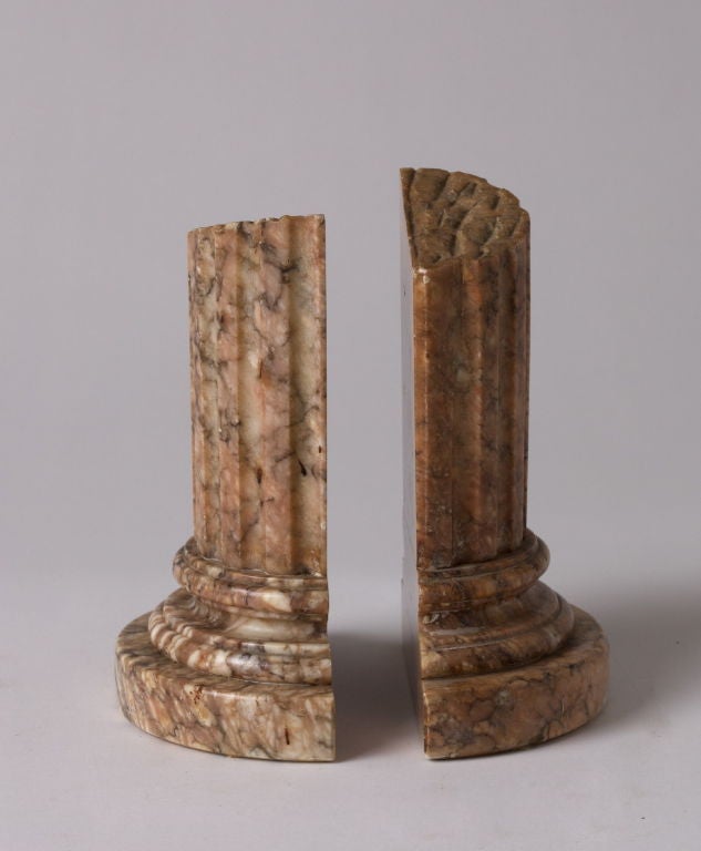 Each in the shape of a column base.