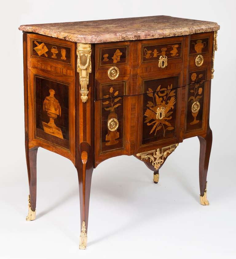 The original Spanish Brocatelle marble above two drawers veneered sans traverse and with a slight breakfront, with a frieze marquetry of teapots and utensils in the Chinese taste all around, and inlaid with a musical trophy flanked by bouquets of