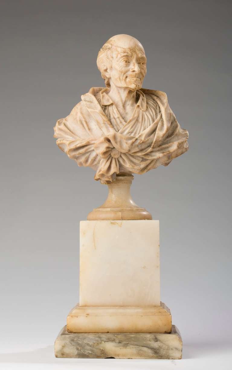 Depicted as an older man, with cloth draped across his shoulders, on a square pedestal with a later stepped base, signed to the underside of the bust 