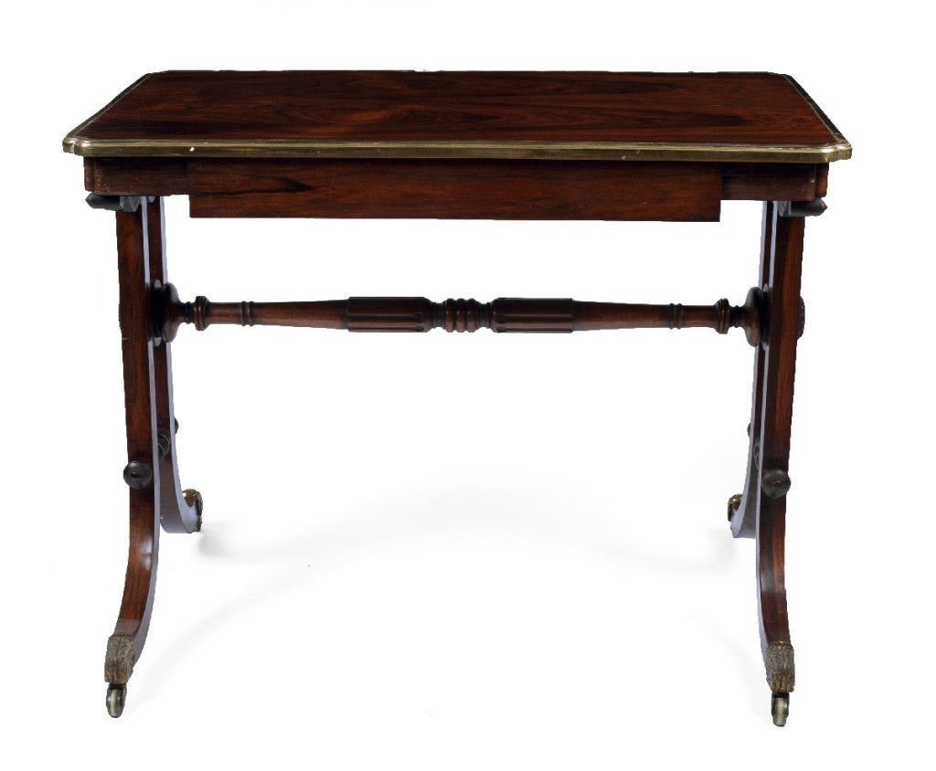 The bronze-mounted rectangular top with rounded incurved corners‚ above a single frieze drawer‚ raised on a trestle base ending in downswept legs on casters joined by a turned stretcher.
This very elegant table beautifully illustrates the most