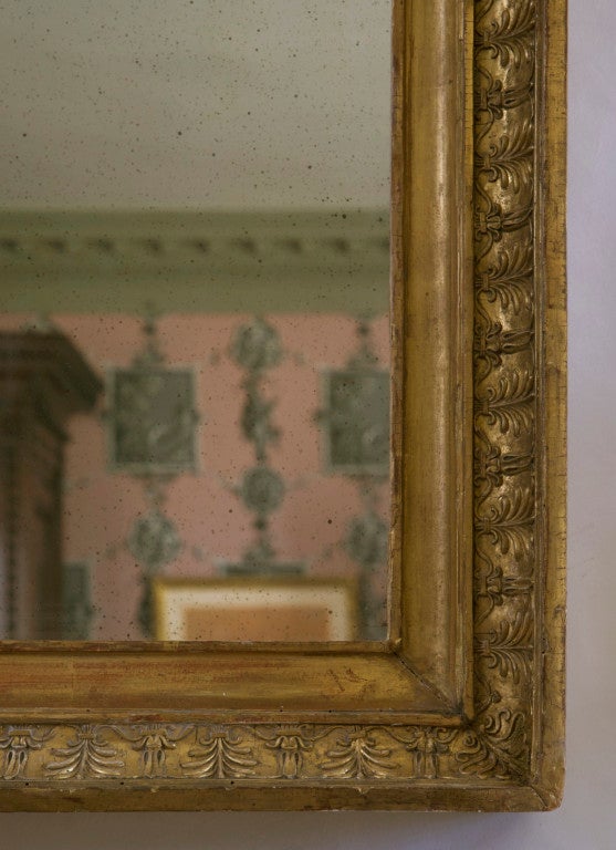 The rectangular mirror plate within a frame decorated with anthemions. Formerly used as a frame.