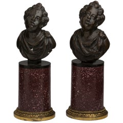 Pair of Italian Patinated Bronze Putti on Gilt Bronze-Mounted Porphyry Bases