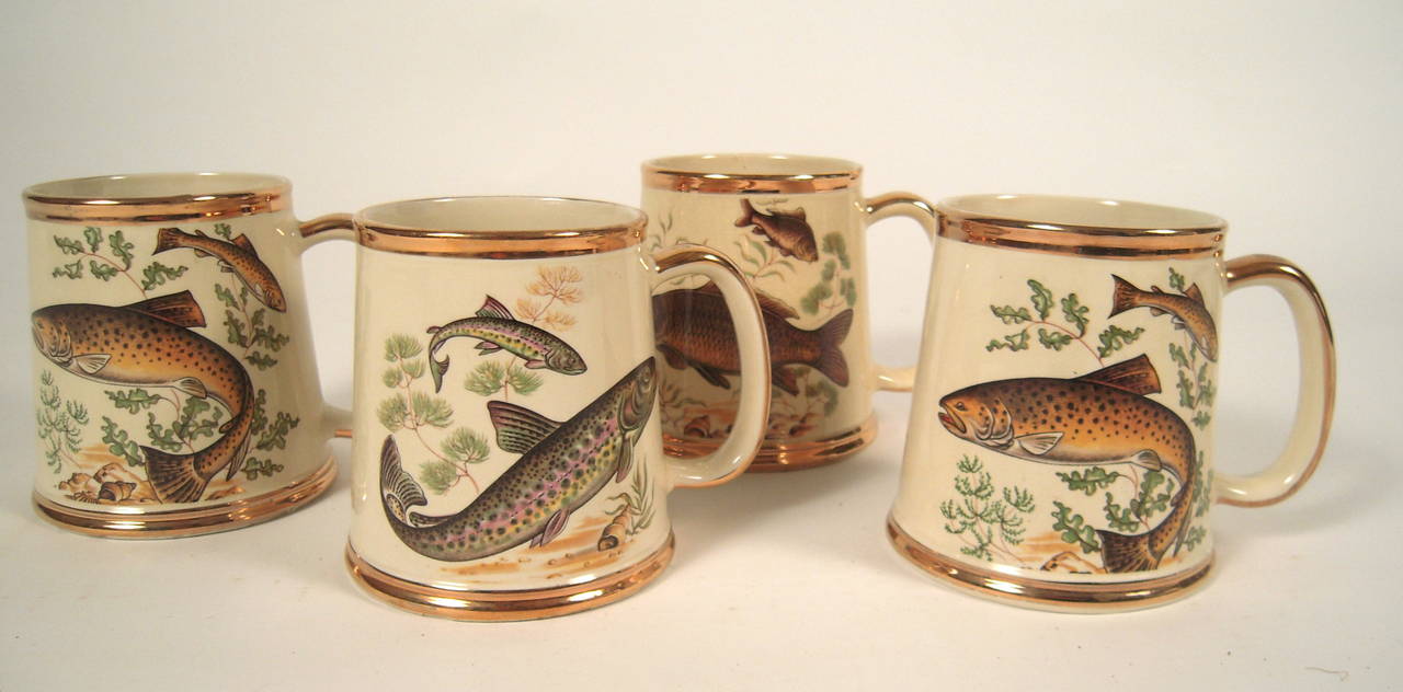 A fine quality set of 4 large Staffordshire mugs, by Gibson's,each decorated with well defined transfer printed fish among vegetation in various colors on a cream ground on the front with a smaller fish on the back, all with gold bands on the top,