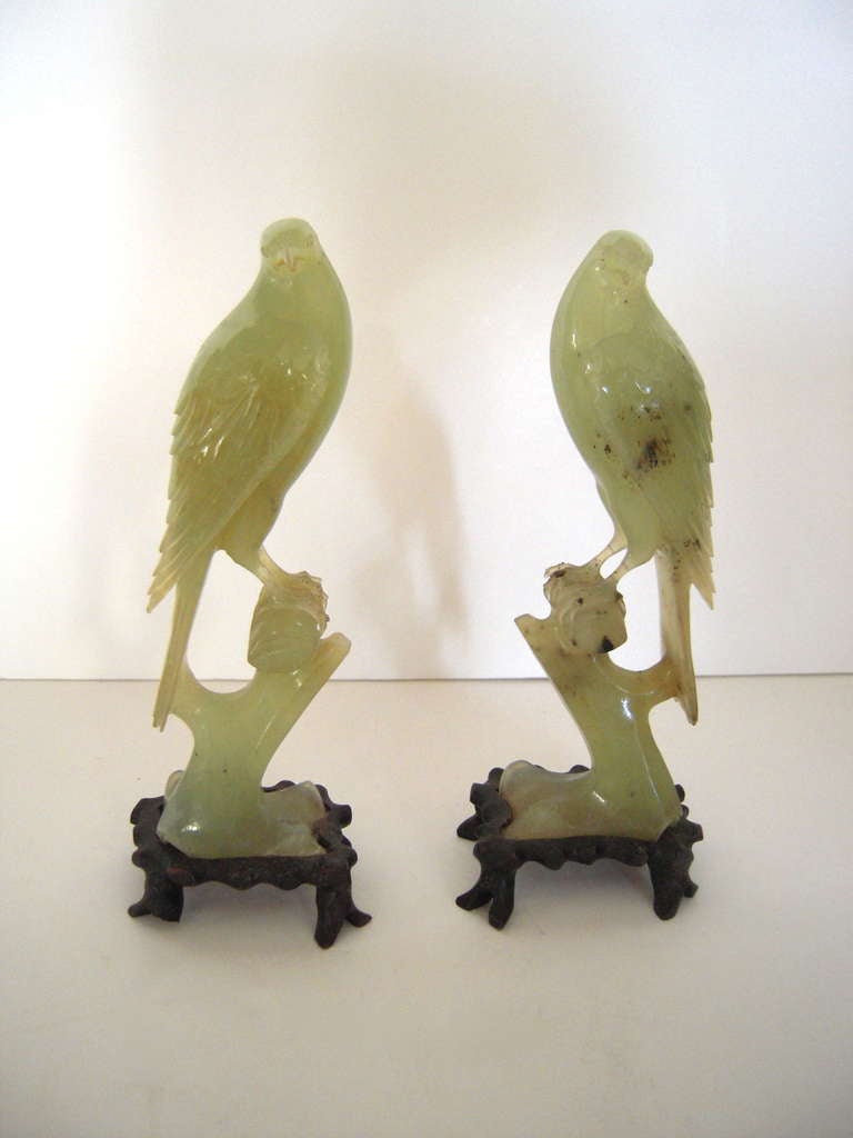 A pair of 19th century Chinese Export carved nephrite jade birds, naturalistically modeled with good detail and perched on wood branch -like plinths. Beautiful on a mantel or table(s).

Provenance: John Cottrell, Stillington Hall, Gloucester,