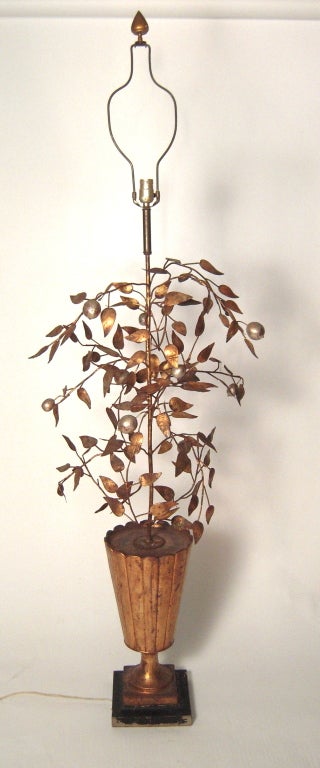 A chic, large scale Italian silver and gold tole/wrought iron lemon tree floor lamp, the naturalistically modeled tree issuing from a scallop edged gold painted  wood vase on a black painted square plinth. Newly re-wired with a new gold lined black