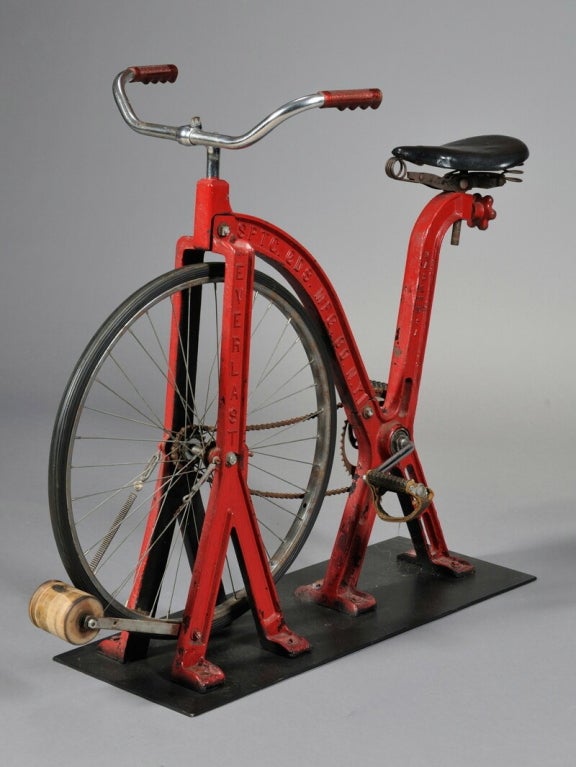 A red painted cast iron stationary exercise bicycle, made by Everlast, 