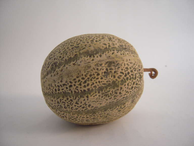 A very realistically modeled French ceramic melon, with wood stock.