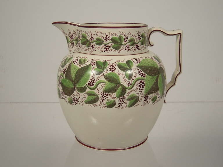 A large Staffordshire pottery pitcher, English circa 1810, with bands of hand painted grapevine decoration, beautifully drawn rich green tones with dark burgundy/brown detailing.

