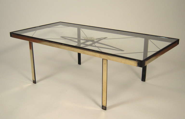 Cocktails and orienteering? A stylish mid century modern rectangular cocktail (or coffee) table, the glass top over a brass and metal trellis design centered by a working compass on four brass and black painted metal legs.