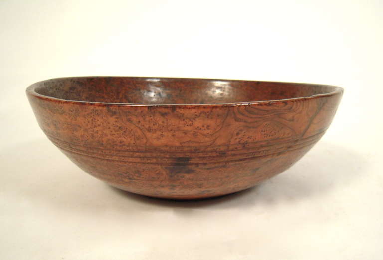 A 19th century American turned burl wood bowl, richly figured and well patinated, with reeded bands and  old varnished surface.