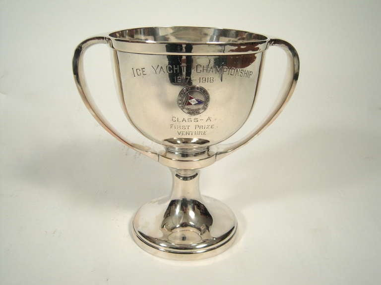 A large  Ice Yacht Championship Trophy for 1917-1918 awarded by the Medford, Massachusetts Boat Club, the silver plated loving cup centered by a red, white ad blue enameled medallion with the Medford Boat Club Burgee and engraved 'Ice Yacht