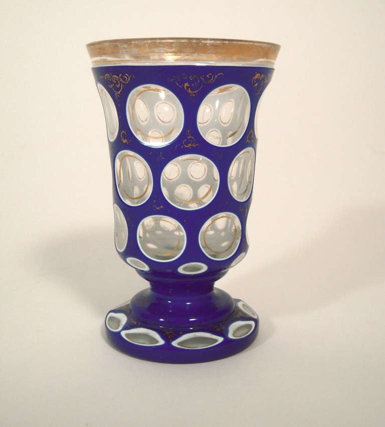 A 19th century cobalt cult to clear goblet with graphic circular decoration, highlighted with gilded ornament. Very fine quality,  possibly Baccarat. Wear to gilding, as seen in photographs.